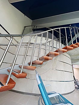 Stainless steel railing on spiral stairs in building