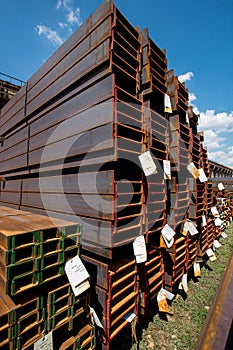 Stainless steel rails deposited in stacks photo
