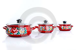 Stainless steel red pots on white background