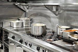 Stainless steel restaurant professional kitchen equipment and work surface.