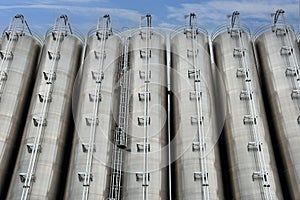 Stainless steel silos against cloudy sky