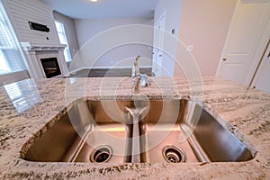 Stainless steel sink with double basin on a kitchen island of newly built house