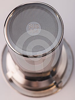 Stainless steel tea strainer infuser close up. Tool for thermos or coffee mug with spill proof lid. Mockup photo