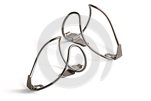Stainless steel water bottle cages for bicycles on white background.