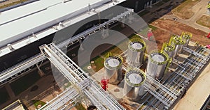 Stainless tanks with pipes at chemical manufacturing plant