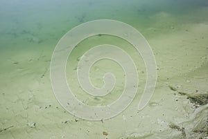 Stains on the sand background. Ripple effect texture. White ground and water with oil in the lake