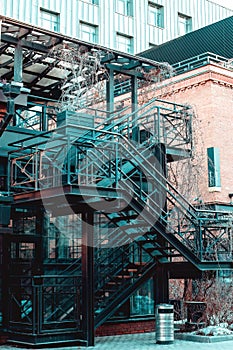 stair for fire escape with the steel railing and ladder on side of building. black outdoor metal staircase construction outside of