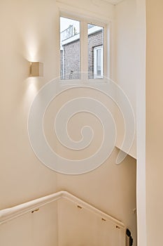 Stair handrails and window on the wall