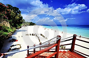 Staircase on a beautiful beach featuring pristine white sand and dazzling blue waters