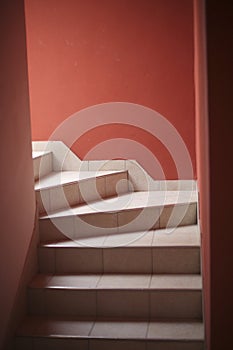 Staircase covered with tiles in the corridor of the house