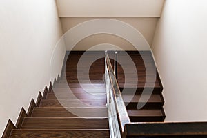 Staircase custom built home interior with wood staircase and white wal