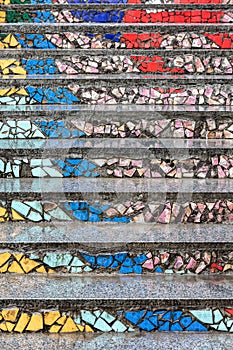 Staircase decorated with colorful pieces of ceramic tiles. urban background