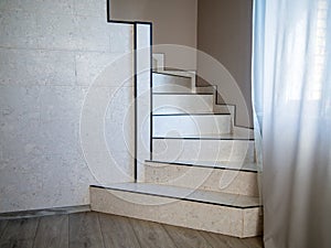 Staircase finished with ceramic tiles and leading to the second floor of the house