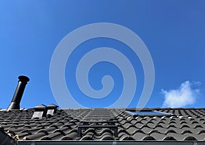 Staircase on gray roof and chimney