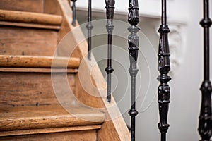 Staircase Handrailing in Old Historic Building. Interior Decor of Vintage Stairs with Metal Ornament and White Wall Background.