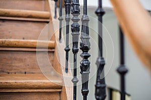 Staircase Handrailing in Old Historic Building. Interior Decor of Vintage Stairs with Metal Ornament and White Wall Background.