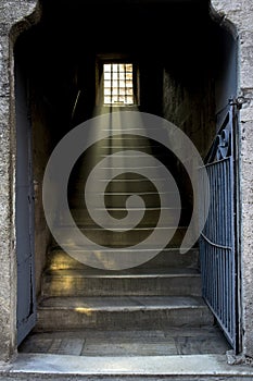 Staircase with light shining through window