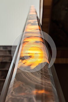 Staircase with marble railing glowing