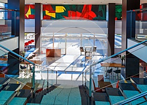 Staircase with metal railing and glass railings in modern hotel