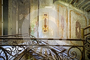 staircase with metal railing in old abandoned house