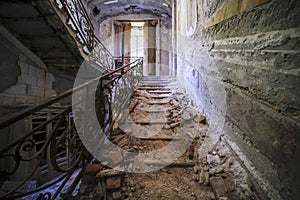 staircase with metal railing in old abandoned house