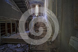 staircase with metal railing in old abandoned house