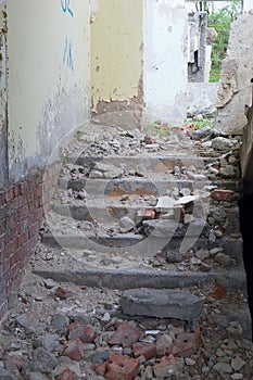 Staircase with old brick wall inside old abandoned building