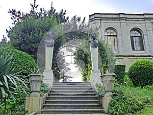 Staircase - pergola with sculptures `Nymph` and `Satyr`. The southern facade of the Yusupov Palace is visible nearby.