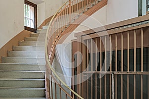 Staircase in prison next to a lattice window photo