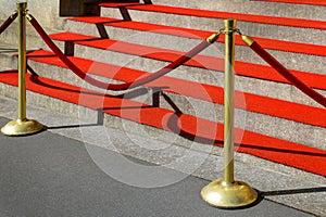 staircase with railings and red carpet