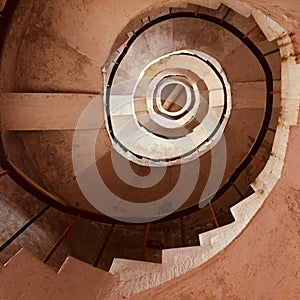 A staircase spiralling upward in a lighthouse photo