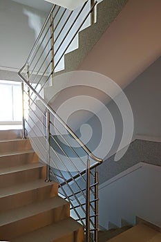 Staircase with stainless steel handrails in a modern high-rise building. The interior of modern buildings. Rise to the top of the