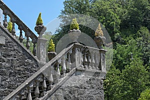 Staircase with stone columns and plant pots at the corners, typical historical garden design in Bagnone, a beautiful city in photo