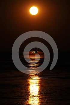 Staircase to the moon phenomenon, moon-rise reflected in the water & mud flats near Broome