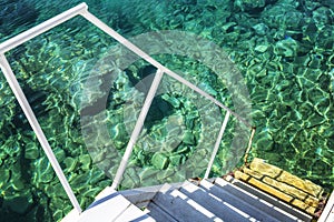 Staircase into the transparent turquoise sea, close-up