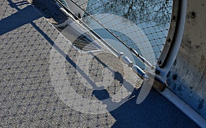 staircase and wide pedestrian bridge with perforated metal floor.