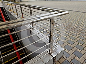 staircase and wide pedestrian bridge with perforated metal floor.