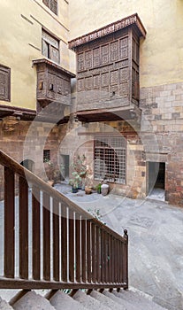 Wooden balustrade revealing patio of ottoman historic house of El Sehemy with wooden oriel windows photo
