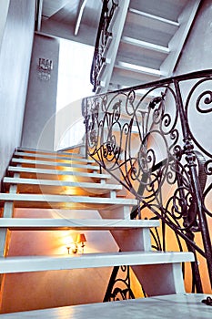 Staircase with wrought iron railing in an empty house