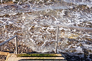Stairs into the Adriatic sea, stone beach water texture, PortoroÅ¾ Piran Slovenia Slovenija, Istria