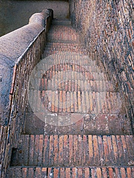 Stairs of ancient fort bricks stairway of castle downstairs way down step staircase stair steps escalier escalera escadariaphoto photo
