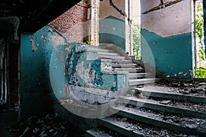 Stairs and broken windows in an abandoned, disaffected building