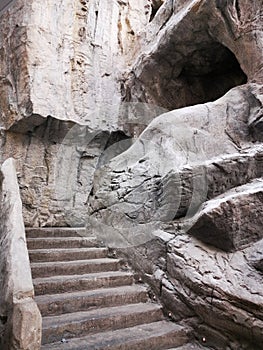 Stairs carved in stone rock - grot photo