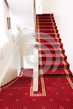 Stairs covered with red carpet