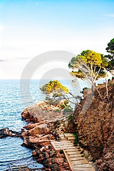 Stairs descending to the sea from the coastal cliff of the Costa Brava, Catalonia, Spain