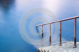 Stairs down to the blue water