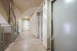 Stairs and elevators in a house with fire doors and stoneware tiles