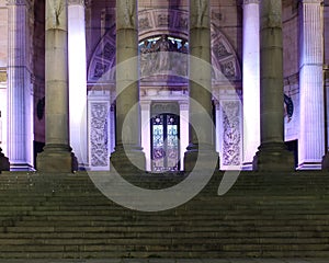 Stairs and entrance of the historic 19th century leeds city hall building illuminated at night