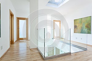 Stairs, glass banister and doors in modern hallway photo