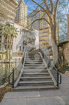 Stairs going up a building overlooking the canal in San Antonio River Walk Texas